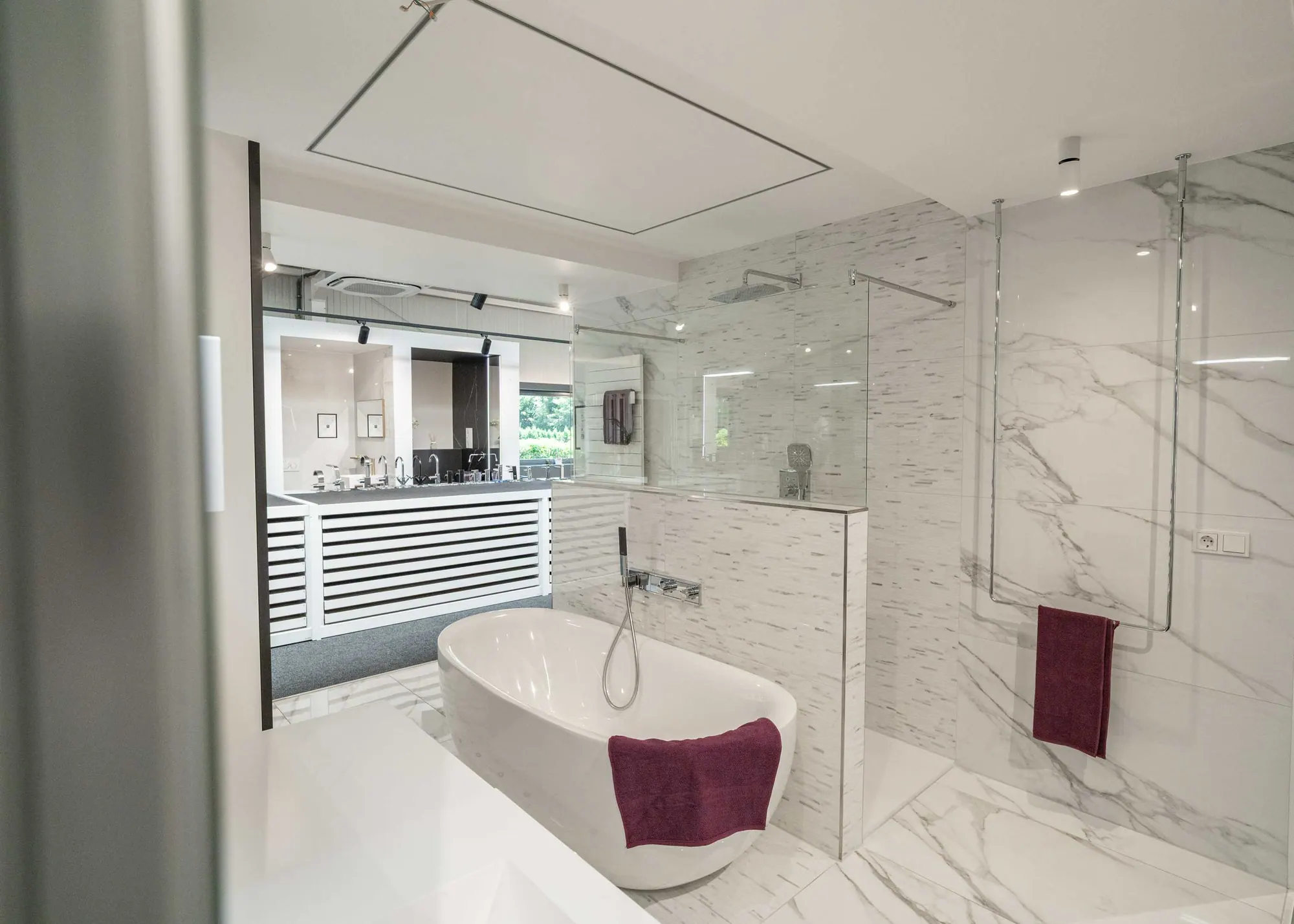 Display bathroom with freestanding bath and marble-effect tiling, JP Home Concept showroom